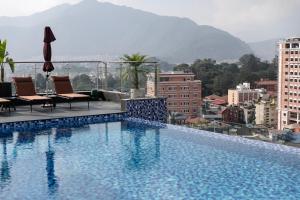 a swimming pool on the roof of a building at Dusit Princess Kathmandu in Kathmandu