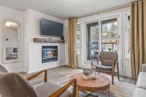 a living room with a fireplace and a table and chairs at NEW! Central Canmore- Whimsical Mountain Retreat in Canmore
