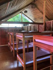 a group of tables and chairs in a room at Surf and Skate Duli El Nido By Kiteclub Palawan in El Nido