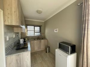 a kitchen with a refrigerator and a microwave at Oaktree in Ermelo