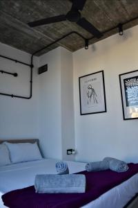 a bedroom with a bed and a table with towels at Chic Penthouse industrial-style in Mosta