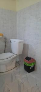 a bathroom with a white toilet in a room at Long Beach Garden Resort in Ko Lanta