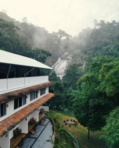 a view of a waterfall from a hotel at Nature Cascade Resort in Chillithodu