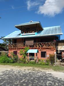 a house with a tin roof on the side of the road at ITAYTAY INN in San Vicente