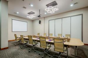 a conference room with a long table and chairs at Flora Al Barsha Hotel At The Mall in Dubai