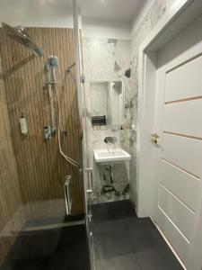 a bathroom with a shower and a sink and a toilet at Hotel Kamil in Kwidzyn +55 photos