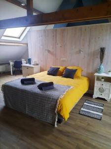 a bedroom with a large bed with yellow sheets at Dolce far niente in Bruges