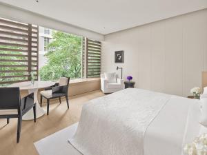 Cama ou camas em um quarto em The Singapore EDITION