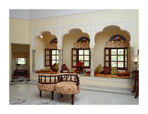 a room with two beds in a room with windows at Patan Mahal in Pātan