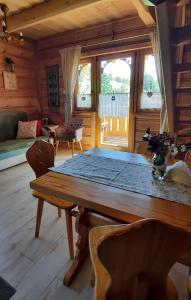 a dining room with a wooden table in a room at Domek Kojsówka in Witów +56 photos