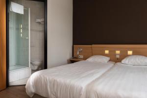Postel nebo postele na pokoji v ubytování Hotel Hoogeerd by Flow Niftrik - Nijmegen