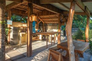 an outdoor dining area with a table and a kitchen at Camanolo Homestay in General Luna