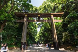 a torii gate in a park with people walking at Elle's Shirokane Guest house 301 in Tokyo