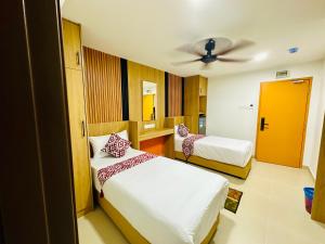 Postel nebo postele na pokoji v ubytování Cozy Hotel@ KL Sentral