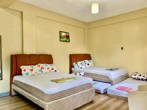 a room with two beds and a couch at Hana Natsu Resorts Beach & Hotel in Morong