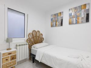 - une chambre blanche avec un lit et une fenêtre dans l'établissement matarolux25, à Mataró