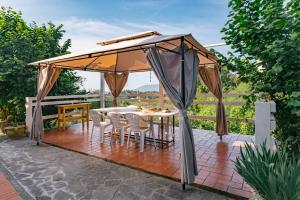 a gazebo with a table and chairs under it at Caterina e l'Indaco in Sarzana