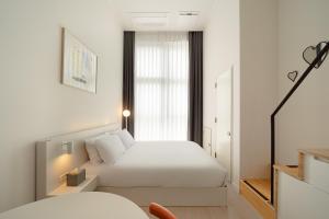 Urbanstay Dangjin Terminal客房内的一张或多张床位
