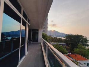 a balcony of a building with a view of the ocean at F1E DeOwl Beachfront Balcony Seaview karaoke condo in Tanjung Bungah