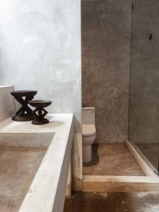 a bathroom with a toilet and a sink and a shower at Heritage Boutique Home in George Town +4 photos