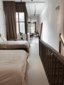 a hotel room with two beds and a balcony at Heritage Boutique Home in George Town