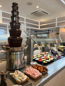 a buffet with many different types of food on a counter at Gran Hotel Flamingo-Adults Only older 18 years old in Lloret de Mar