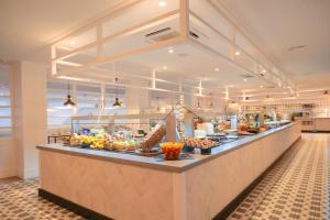 a buffet line with food on display in a restaurant at Gran Hotel Flamingo-Adults Only older 18 years old in Lloret de Mar