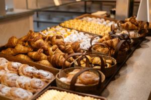 a bunch of different types of pastries on a counter at Gran Hotel Flamingo-Adults Only older 18 years old in Lloret de Mar