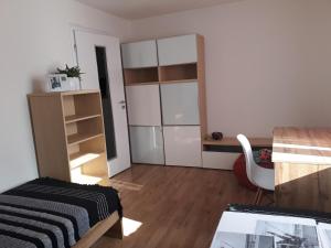 a bedroom with a bed and a desk and a chair at 3 izbovy RD - bungalow in Bernolákovo
