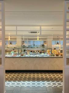 a large kitchen with a counter in a restaurant at Gran Hotel Flamingo-Adults Only older 18 years old in Lloret de Mar