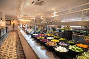 a buffet line with many bowls of food at Gran Hotel Flamingo-Adults Only older 18 years old in Lloret de Mar