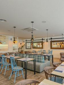 a restaurant with tables and chairs and a couch at Gran Hotel Flamingo-Adults Only older 18 years old in Lloret de Mar
