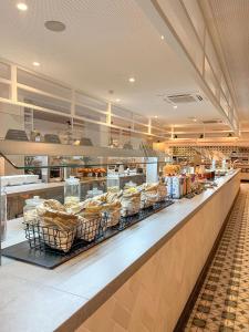 a bakery counter with many racks of bread at Gran Hotel Flamingo-Adults Only older 18 years old in Lloret de Mar