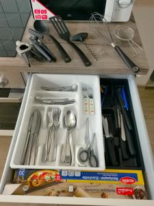 a drawer filled with silver utensils on a counter at FeWo Robin in Bad Harzburg