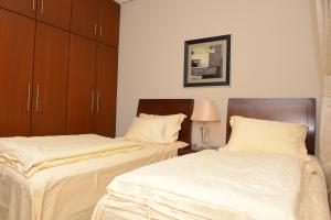 Ліжко або ліжка в номері AlSharq Residence