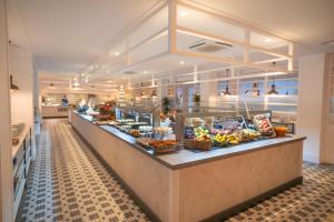 a buffet line with food on display in a restaurant at Gran Hotel Flamingo-Adults Only older 18 years old in Lloret de Mar