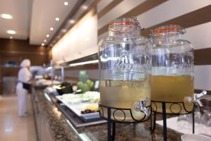two glass jars filled with wine sitting on top of a counter at Hotel Pabisa Chico in Playa de Palma