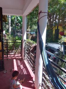 een kind op een veranda met een hangmat bij Kioga home stay in Arusha