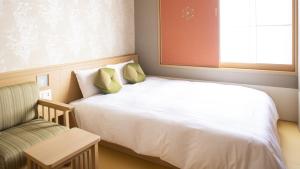 a small bedroom with a bed and a chair at Onyado Nono Kyoto Shichijo Natural Hot Spring in Kyoto