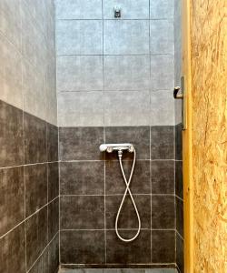 a shower with a hose in a bathroom at Camp Dunes Insolites Sabria in Sabria