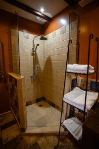 a bathroom with a shower with a glass door at Piazza Boutique Hotel in Batumi