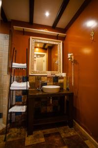 a bathroom with a sink and a mirror at Piazza Boutique Hotel in Batumi