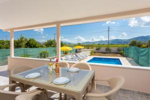 a patio with a table and chairs and a pool at Villa Corals in Dalyan