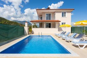 a villa with a swimming pool and a house at Villa Corals in Dalyan