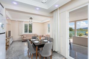 a dining room and living room with a table and chairs at Villa Corals in Dalyan