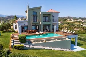 a villa with a swimming pool and a house at Villa Pasiphae in Stalos