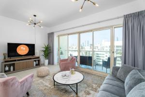 a living room with a couch and a tv at EasyGo - Al Samar 4 - 2 Bedroom & Maid in Dubai
