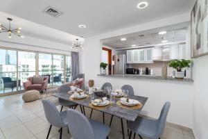 a dining room and living room with a table and chairs at EasyGo - Al Samar 4 - 2 Bedroom & Maid in Dubai