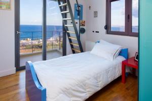 a bedroom with a bed and a ladder at Villa Pasiphae in Stalos +60 photos