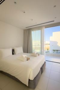 a bedroom with a large bed and a large window at City Napa Seaview Villas - Villa 8 in Ayia Napa